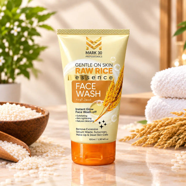 A tube of Mark 30 Professionals Raw Rice Face Wash stands on a marble surface with rice grains, a wooden bowl, and folded white towels in the background, creating a natural, spa-like setting.